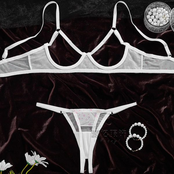 White sheer bra and panty set with delicate straps, displayed on dark velvet with pearls and flowers for valentines day.