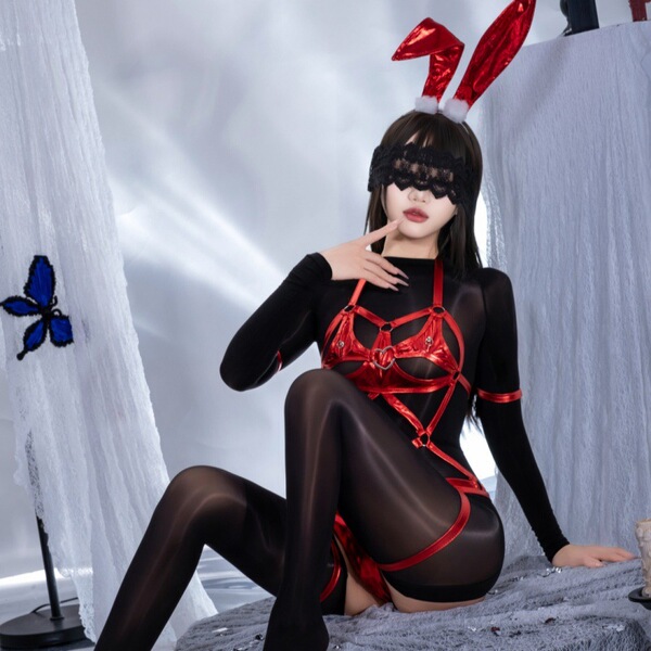 A woman poses in a dark fantasy role play outfit featuring a bunny girl latex-style bondage set with adjustable restraints, c...