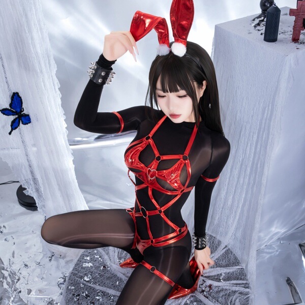 A woman poses in a dark fantasy role play outfit featuring a latex bunny girl design with red bondage elements and adjustable...