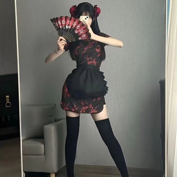Woman wearing a plus size chinese style cheongsam lingerie set with apron, holding a fan in a retro maid dress outfit.