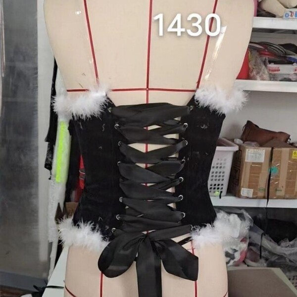Elegant victorian-style corset with black ribbon lacing and fluffy white accents, perfect for holiday-themed outfits.