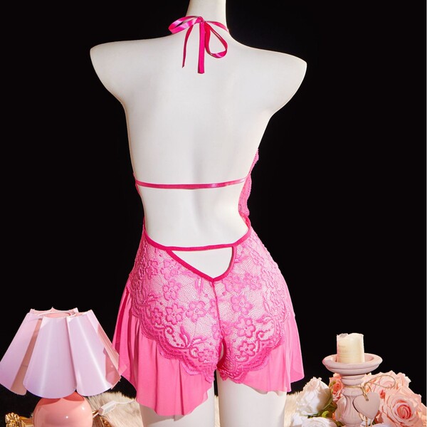 Pink lace bodysuit with halter neck and cut-outs, sheer design, perfect for women seeking elegant sleepwear.