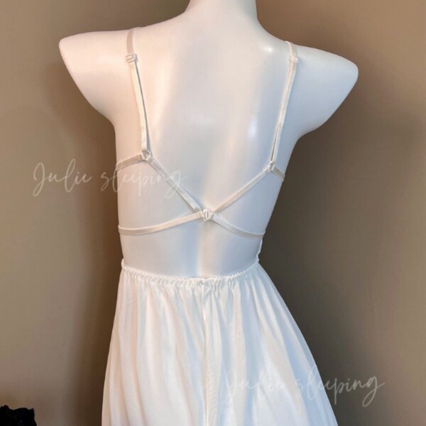 White plus size satin chemise set with lace trim and adjustable ties, shown on mannequin from back view.