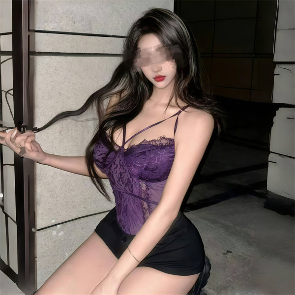 Curvy woman wearing purple lace lingerie set with thin straps and matching panties, showcasing elegant design.