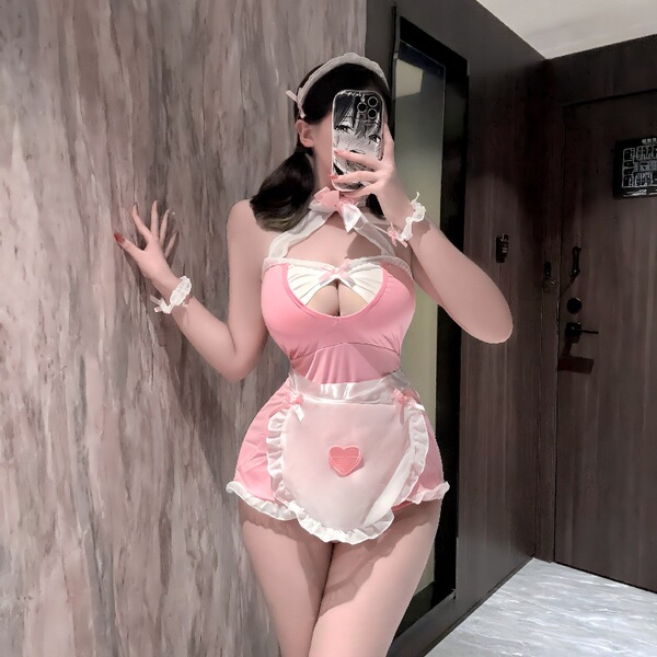 Woman modeling pink plus size maid costume lingerie set with apron, headband and wrist cuffs in mirror selfie.