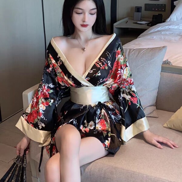 A woman wears a plus-size seductive geisha kimono-inspired erotic costume, featuring a low neckline and floral patterns, perf...