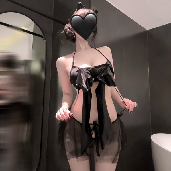 Woman wearing black sheer mesh sleep dress with open-crotch design and bow detail, ideal for role play or lingerie occasions.
