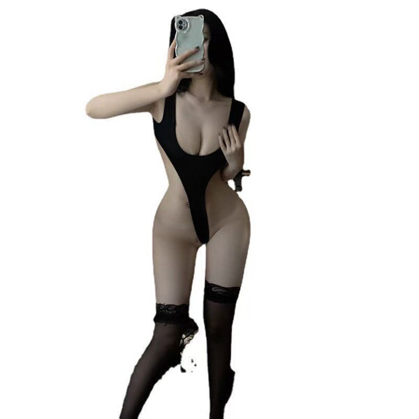 Woman in black open-crotch bodysuit with thigh-high stockings, showcasing a sexy lingerie set for plus size allure.