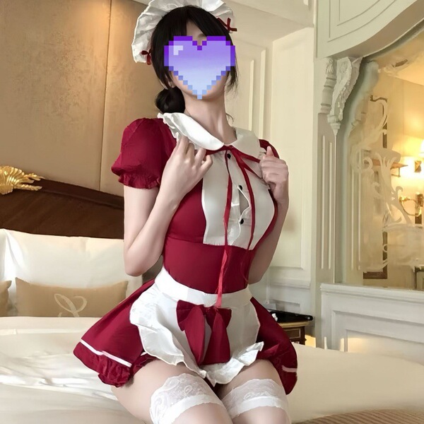 A woman poses in a red and white maid costume set, featuring a cute apron and stockings, perfect for a french maid look.