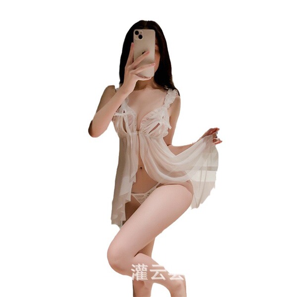 Woman wearing plus size sexy sleepwear, a busty allure lace trimmed slip dress, posing in bedroom tease nightgown.