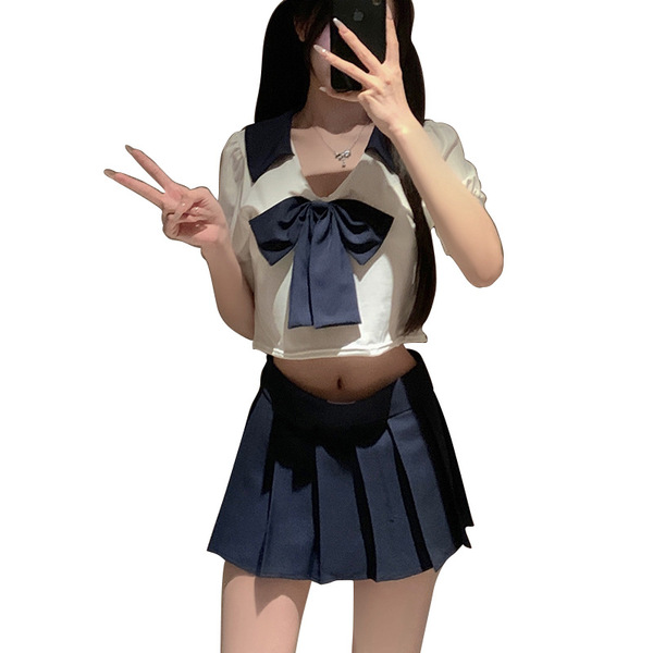 A stylish japanese-inspired jk uniform set featuring a white crop top with a navy blue bow and pleated skirt, perfect for plu...