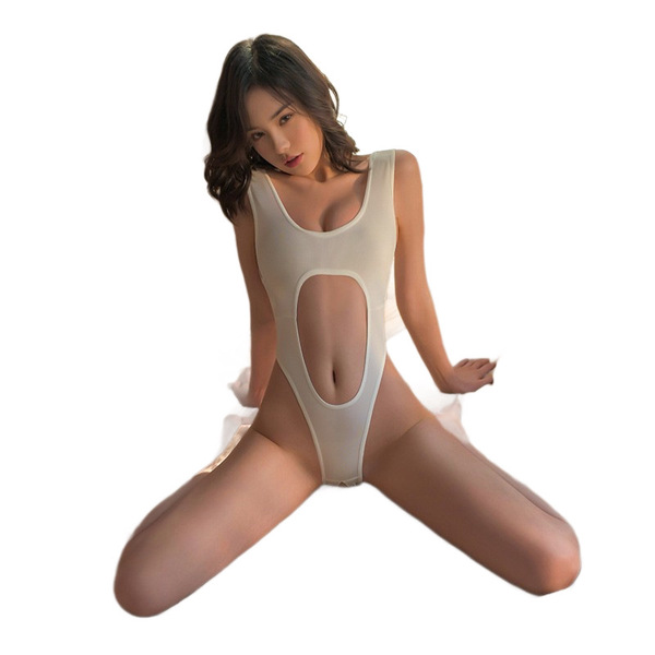 Woman wearing a sheer ice-silk open-crotch bodysuit with elegant cutouts, posing seductively in minimalist sleepwear.