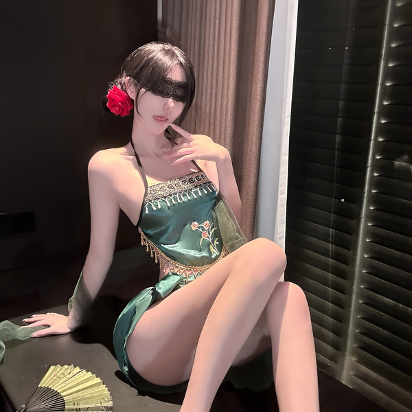 A woman poses elegantly in a sensual, green exotic bralette set with floral embroidery, perfect for intimate moments. the min...