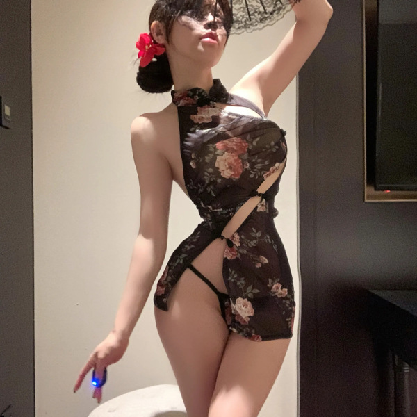 Woman modeling sheer vintage qipao dress with floral pattern, high slit, and lace trim; elegant and alluring costume outfit.