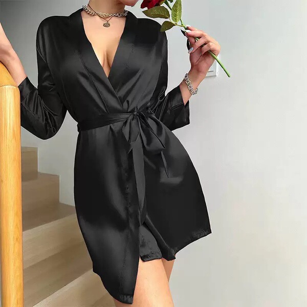 A woman elegantly poses with a rose, wearing a sleek black sleep dress made from lightweight ice silk fabric. the dress featu...