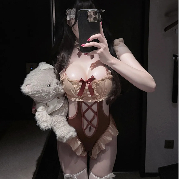 Woman in cute bear-themed lingerie bodysuit with adjustable straps, holding plush toy.