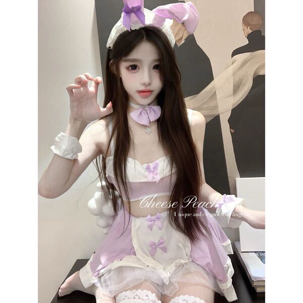 Woman wearing pure & playful bunny girl lingerie set – sexy cute sleepwear with purple bows, ears, and lace trim.