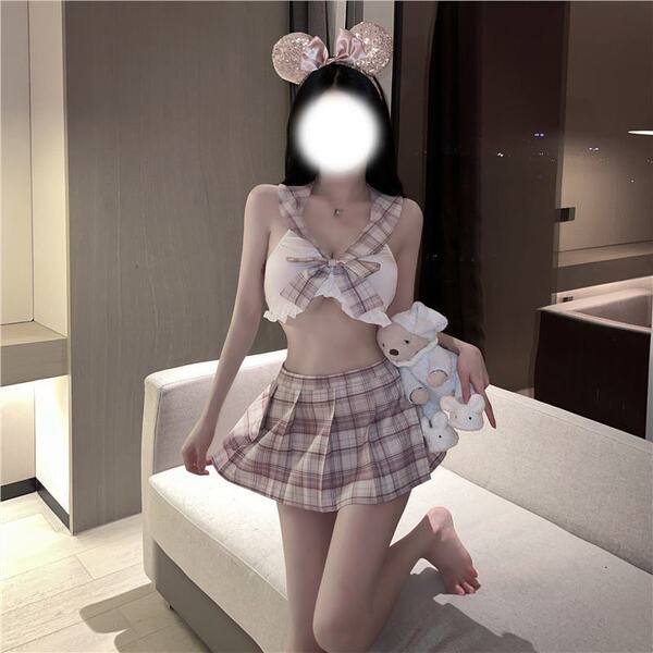 Woman in pure & playful jk sleepwear set with plaid skirt, bow top, and mouse ears, holding plush toy.