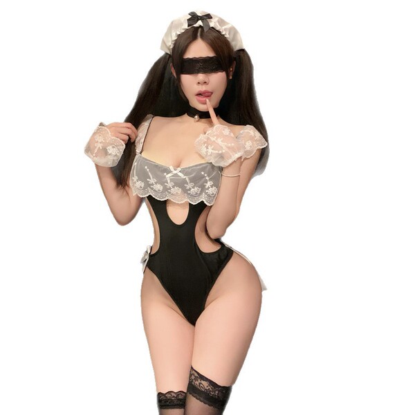 Woman wearing black and white maid lingerie set with lace details, blindfold, and thigh-high stockings.