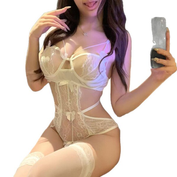 Woman in white lace lingerie set with sheer bodice, garter straps, and matching stockings. seductive sleepwear style.