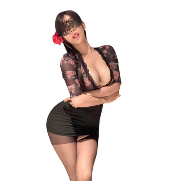 Woman in black floral lingerie set with bodycon skirt, lace details, and red flower hair accessory.