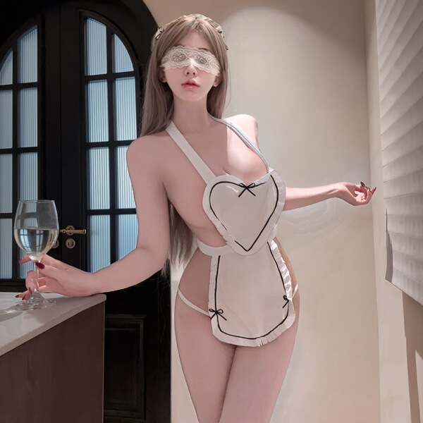 Woman wearing pure & playful lingerie set – sheer belly dance top with open-crotch chef-style design, holding wine glass.