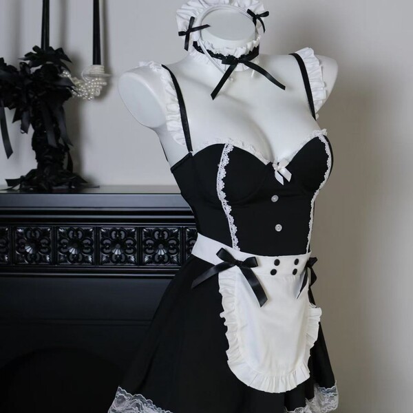 Black and white maid-style lingerie set with lace trim, corset top, apron, and matching headpiece on mannequin.