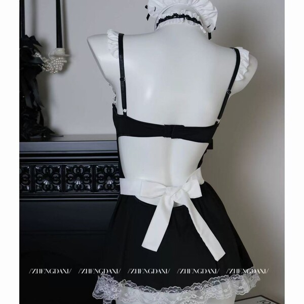 Back view of pure & playful lingerie set: black dress with white lace trim, bow waist, and maid-style headpiece.