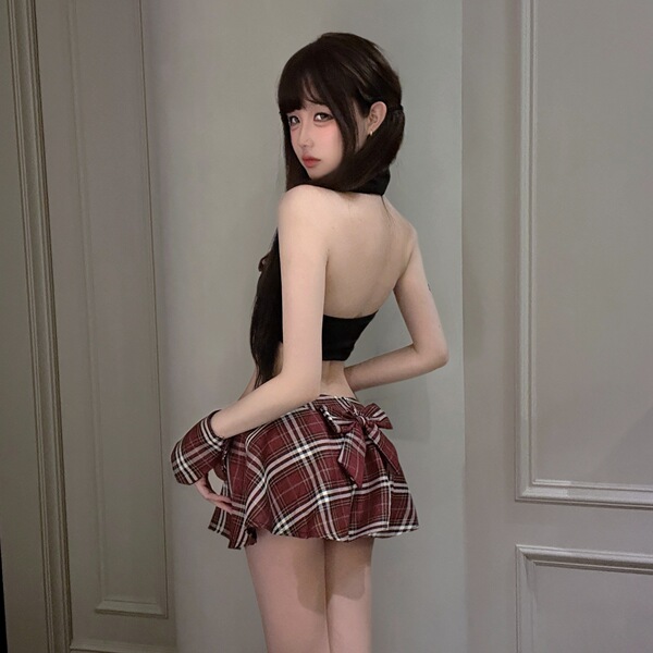 Woman modeling pure & playful lingerie set: sensual jk-style pleated mini skirt with matching top, sexy schoolgirl look.