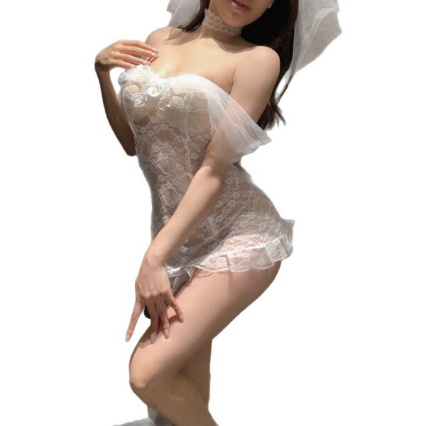 Woman in white lace bridal lingerie set with sheer details and veil, romantic sleepwear style.