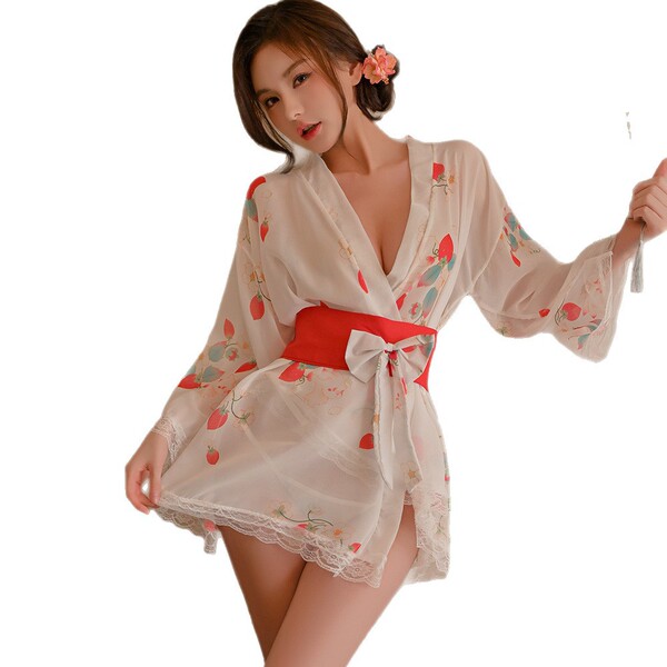 A woman models a sheer, strawberry-patterned kimono-style sleepwear set from pure & playful. features include lace detailing ...