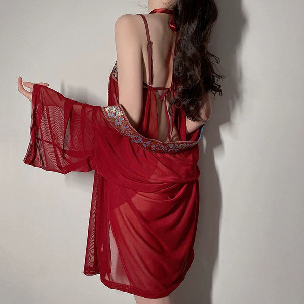 A woman models a red sheer mesh sleep dress featuring intricate embroidery, inspired by traditional chinese designs, perfect ...