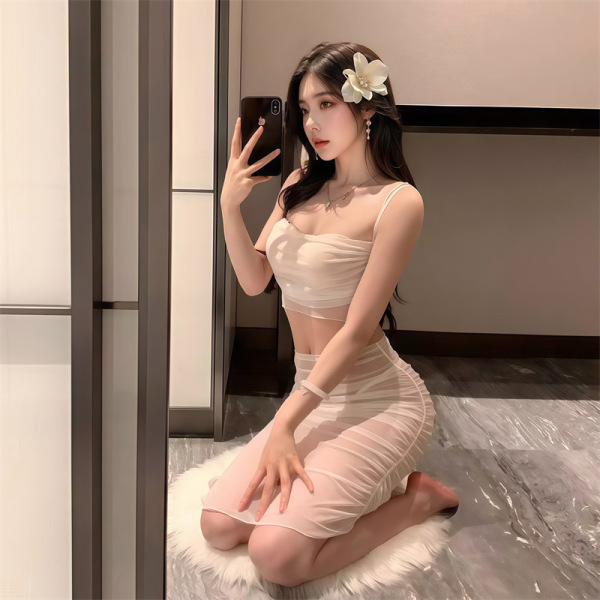 Woman in a sheer lace bodysuit dress, posing seductively with a flower in her hair.