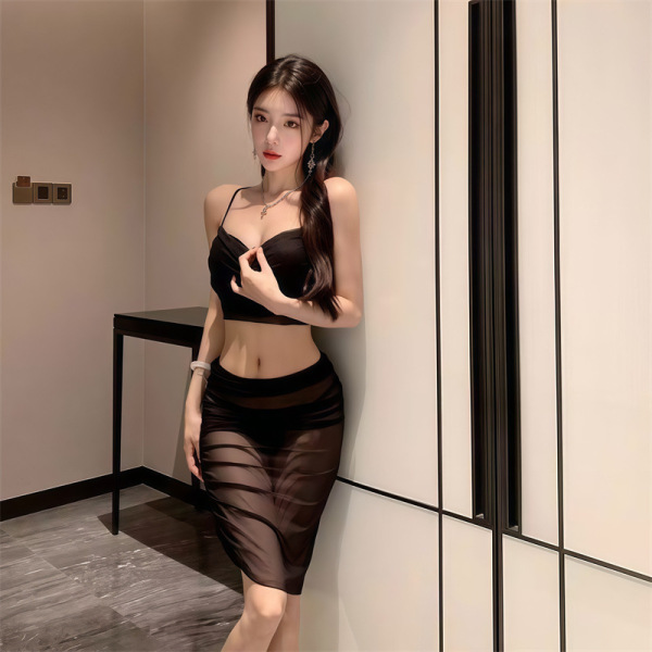Woman wearing black sheer lace bodysuit dress, elegant lingerie set with transparent skirt and crop top, stylish sleepwear ou...