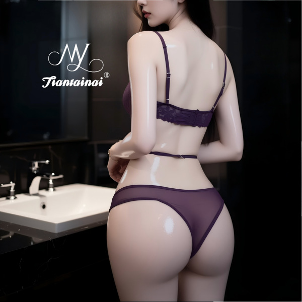 Woman wearing purple lace lingerie set in bathroom, featuring sheer bra and matching panties from pure & seductive collection...