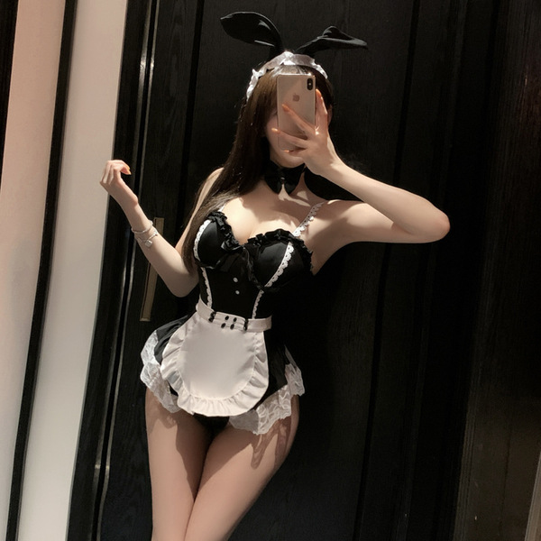 Woman posing in mirror wearing black and white maid costume lingerie set with bunny ears, featuring lace trim and apron.