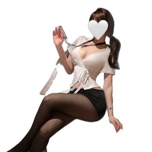 A woman poses with a heart-shaped mask over her face, wearing a white blouse tied at the front and black stockings, showcasin...