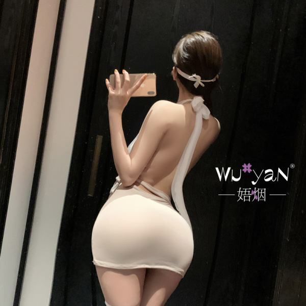 Woman wearing pure & seductive lingerie set, a sexy secretary-style outfit with elegant backless design and bow details.