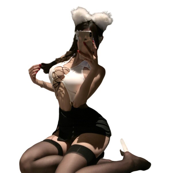 Woman in white top, black skirt, and stockings with open-crotch design, holding a phone.