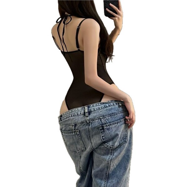 Woman wearing black lace halter bodysuit with jeans, showcasing back view of pure & sexy cropped lingerie-inspired top.
