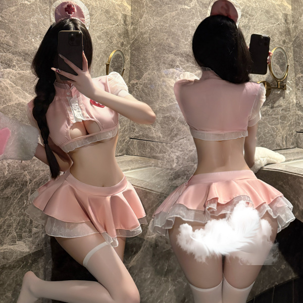 Woman modeling pink pure temptation nurse costume with lace lingerie, flirty petticoat skirt, and fluffy tail in bathroom mir...