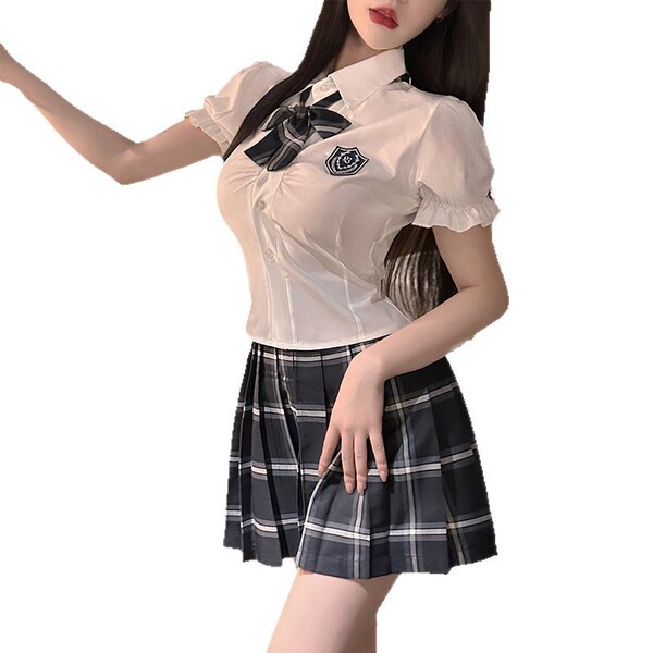 A woman models a cute japanese school uniform set featuring a white blouse with a black bow tie and a plaid skirt, embodying ...