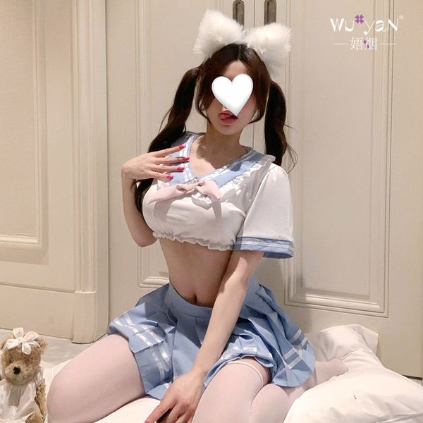 A person wearing a playful schoolgirl costume, featuring a white sailor-style top with blue accents and a matching pleated sk...