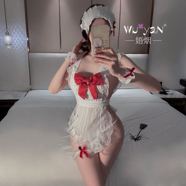 Woman in white lace lingerie set with red bows, posing on bed; includes headpiece and garters. pure & tempting maid costume s...