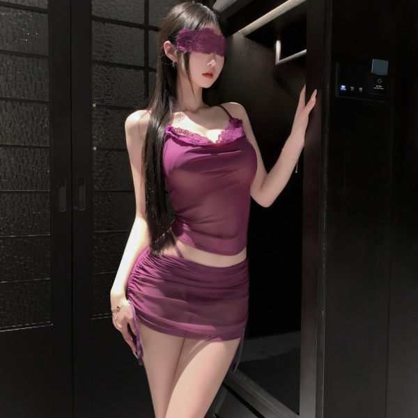 Woman in purple lace-trimmed camisole and open-crotch bodycon skirt from pure & tempting lingerie set, posing by dark doorway...