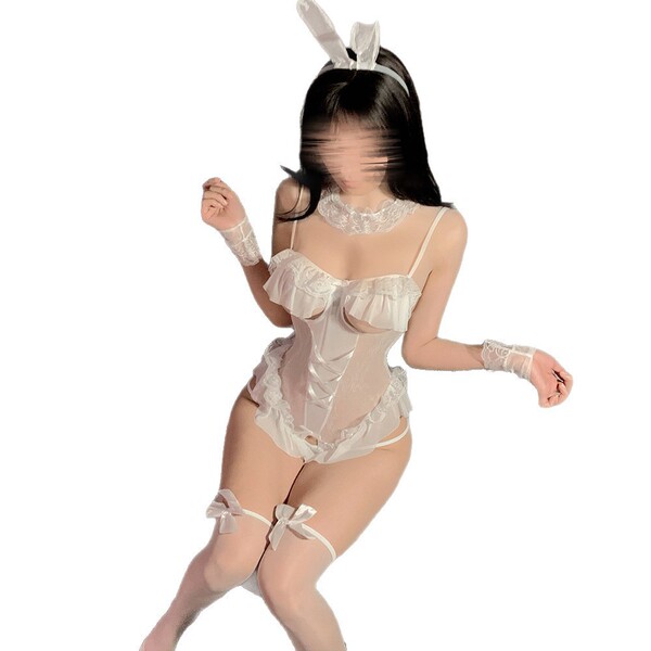 Woman wearing white bunny girl lingerie set with lace, bow headband, garters, and open-crotch design for sleepwear.