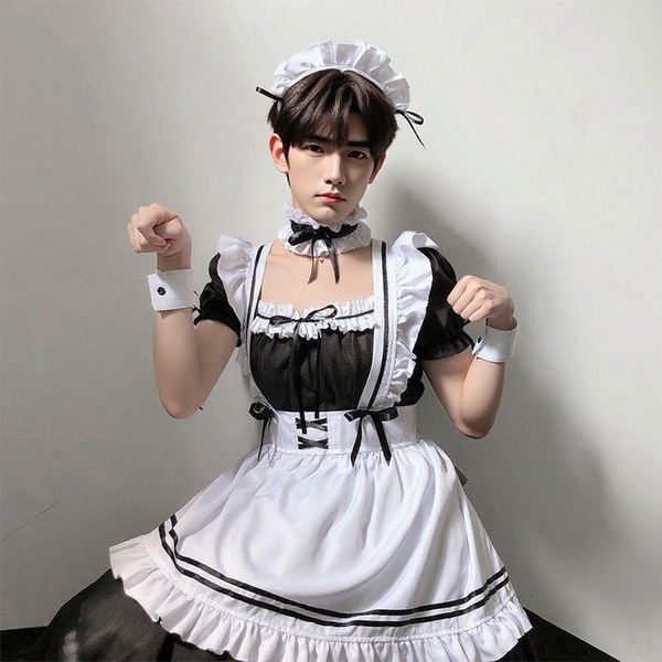 A person wearing a black and white maid costume set, featuring ruffled sleeves, a corset-style bodice, and a full skirt, posi...