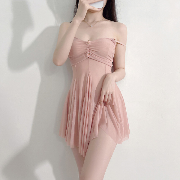 Woman modeling pink lace sleepwear set with sheer mesh cami and shorts, designed for small bust enhancement.