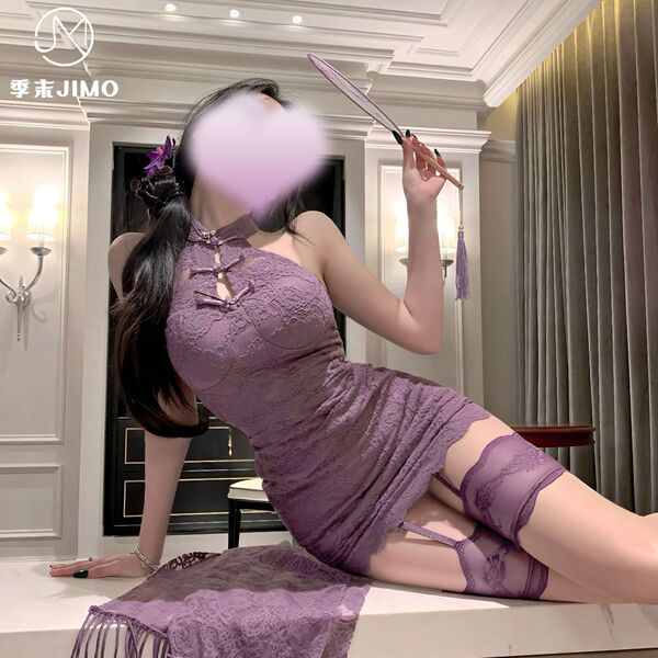 A woman poses elegantly in a purple lace cheongsam dress with hook-neck design and vintage buttons, paired with matching stoc...