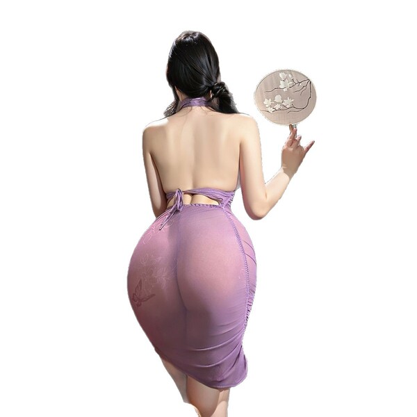 A woman models a purple lace bodysuit set, featuring sheer fabric and delicate floral patterns, perfect for seductive sleepwe...